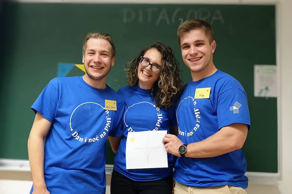 Me and two friends in front of a blackboard at the Faculty's open house event.